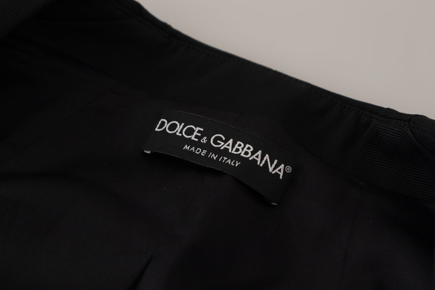 Dolce & Gabbana - Veste noire élégante à boutons-pression avec doublure en soie